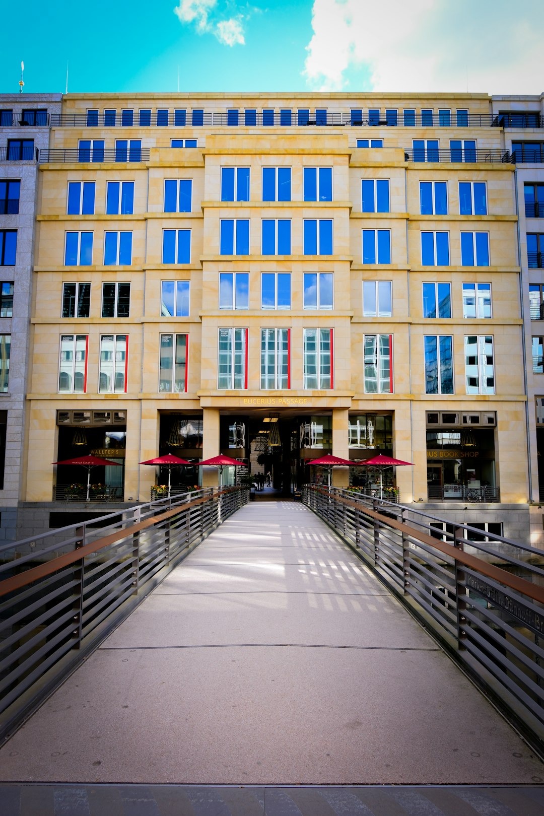 portfolio-03 modern-building-with-blue-windows-and-red-umbrellas-t0sfbemziu